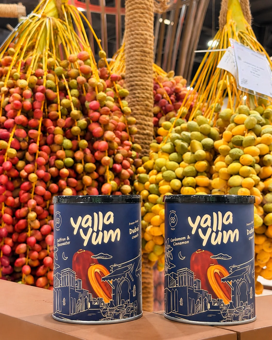Two Dubai Crunch cans displayed at a date market